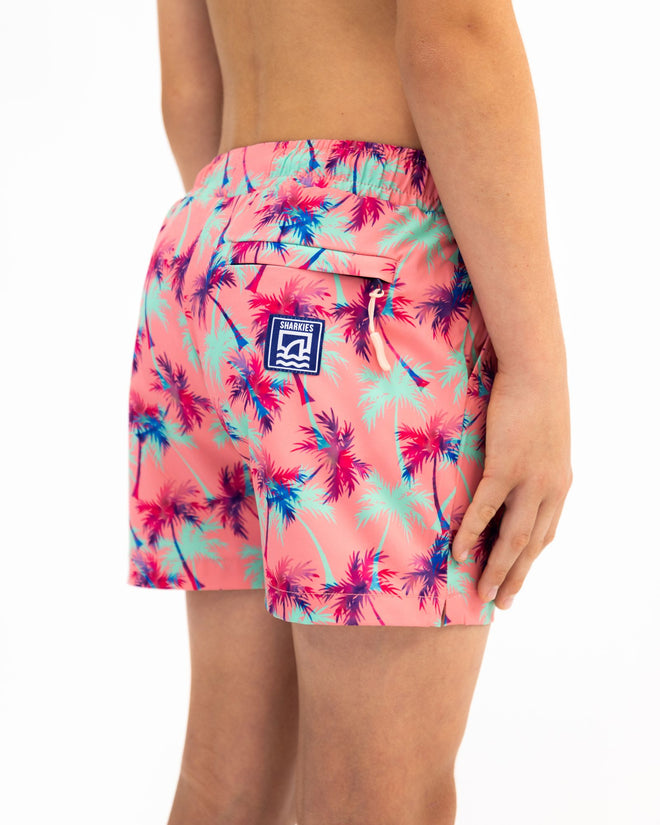 Sharkies Swimwear Falling Palms Positano Swim Shorts featuring a tropical palm print design with vibrant colors. Perfect for beach and poolside wear.