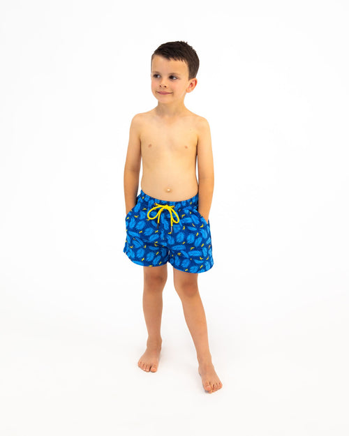 Sharkies Swimwear Boys Swim Shorts featuring a playful feather and stork print. Bright and colorful design ideal for young boys, perfect for swimming and beach outings