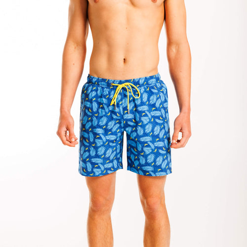 Men's swim shorts featuring a tropical print with falling palm trees against a pink background. The shorts have an elastic waistband with a drawstring and a back zipped pocket, designed for a relaxed, beach-ready look.